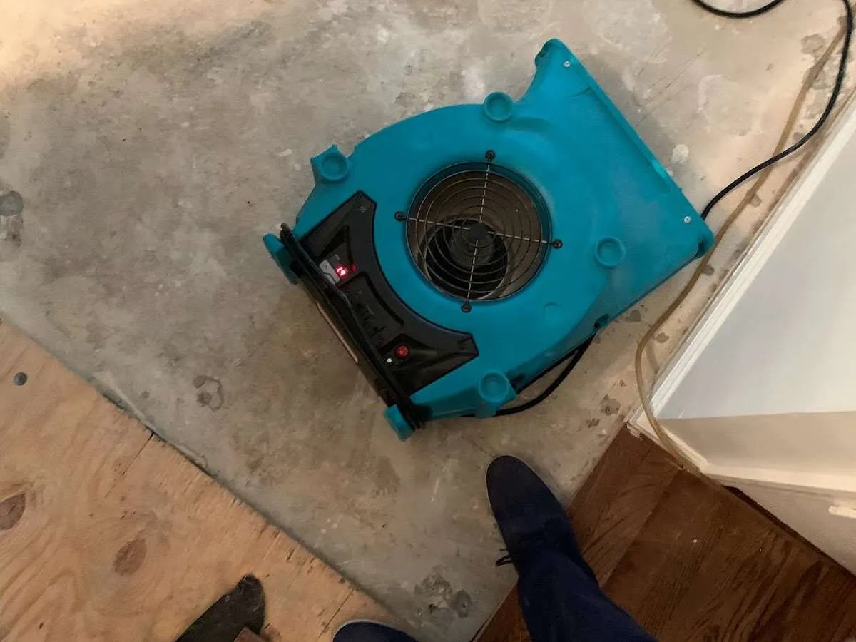 Air mover drying subfloor during Commercial Water Damage Restoration in Willoughby Hills